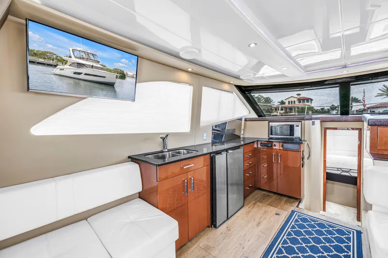 Slide: The Image of Luxurious interior of 2018 Carver 40 Command Bridge yacht with modern kitchen amenities. - 29