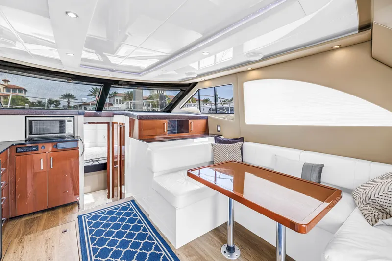 Slide: The Image of Luxurious interior of 2018 Carver 40 Command Bridge yacht with modern seating and kitchen area. - 30
