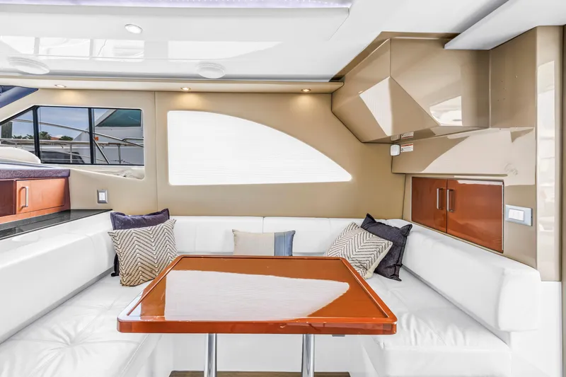 Slide: The Image of Luxurious interior of 2018 Carver 40 Command Bridge yacht with white seating and wooden table. - 31