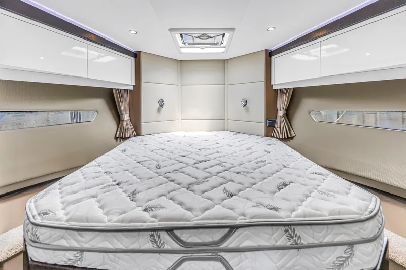 Slide: The Image of Luxurious bedroom interior of 2018 Carver 40 Command Bridge yacht with plush bedding. - 32