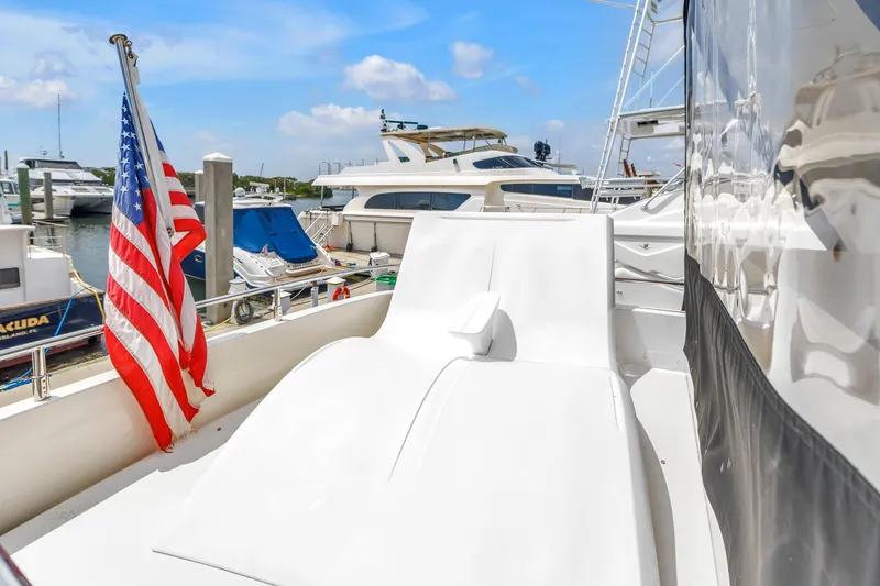 Slide: The Image of 2018 Carver 40 Command Bridge yacht with American flag, docked at marina under blue sky. - 39