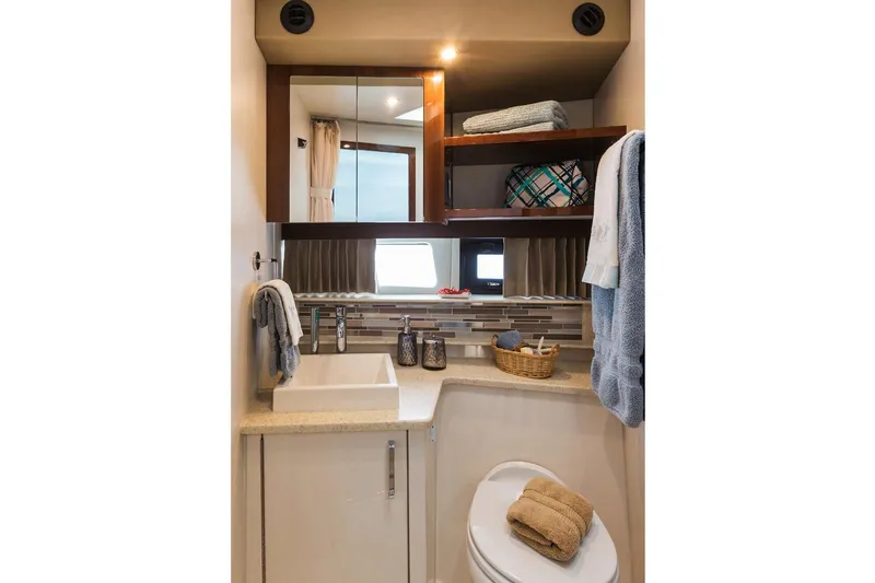 Slide: The Image of Manufacturer Provided Image: 2018 Carver 40 Command Bridge bathroom with modern fixtures and storage shelves. - 7