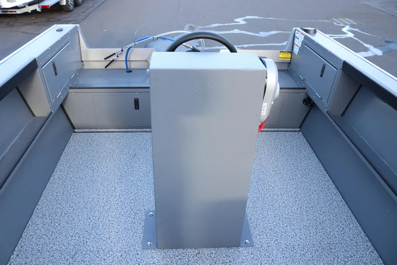 Slide: The Image of 2026 Alumaweld Adventurer 20 boat interior with steering console and storage compartments. - 10