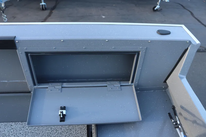 Slide: The Image of 2026 Alumaweld Adventurer 20 boat storage compartment with open hatch and latch. - 12