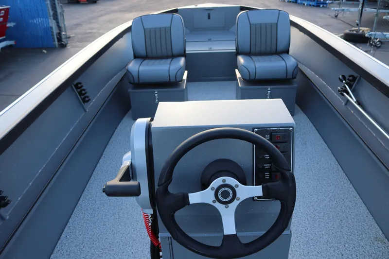 Slide: The Image of 2026 Alumaweld Adventurer 20 boat interior with steering wheel and seating. - 17
