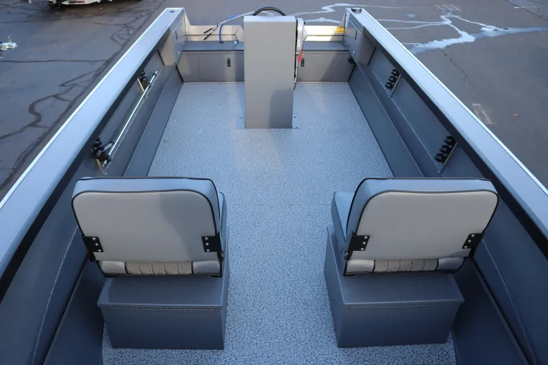 Slide: The Image of 2026 Alumaweld Adventurer 20 boat interior with two gray seats and a steering console. - 21