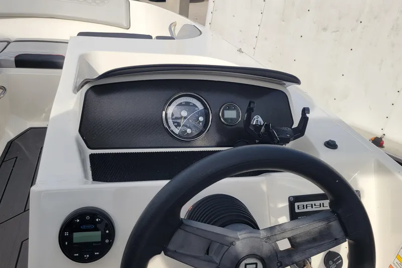 Slide: The Image of 2022 Bayliner Element M17 boat dashboard with steering controls and gauges. - 10