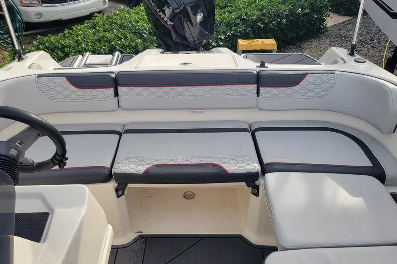 Slide: The Image of 2022 Bayliner Element M17 boat interior with cushioned seating and speaker. - 17