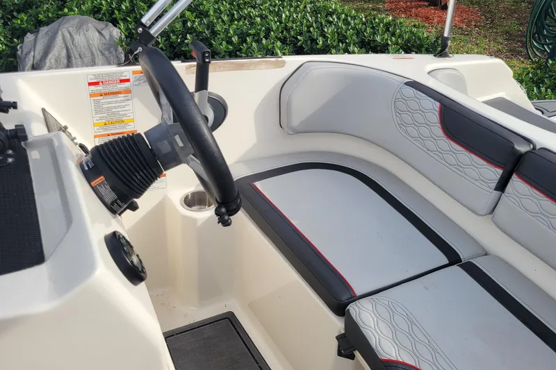 Slide: The Image of 2022 Bayliner Element M17 boat interior with cushioned seating and speaker. - 19
