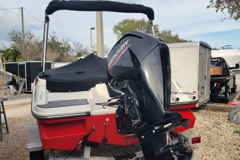 Slide: The Image of Red 2022 Bayliner Element M17 boat on trailer, parked outdoors. - 24