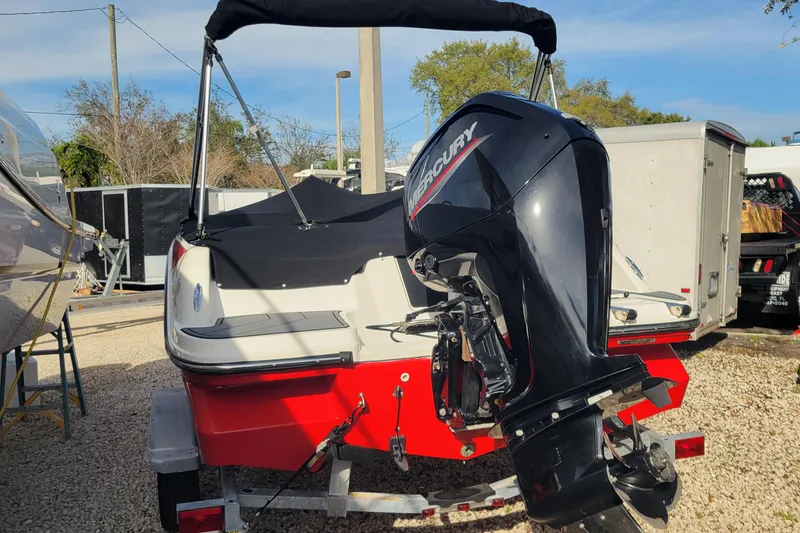 Slide: The Image of 2022 Bayliner Element M17 boat engine on gravel near greenery. - 5