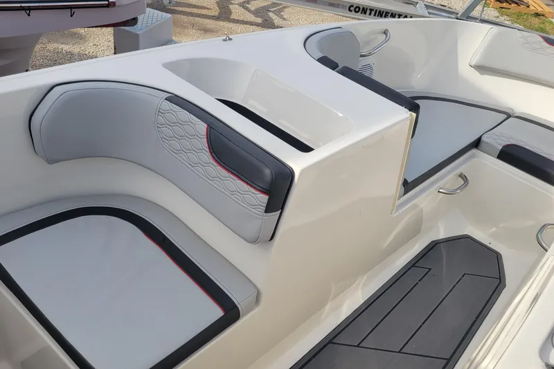 Slide: The Image of 2022 Bayliner Element M17 boat interior with seating and cup holders. - 8