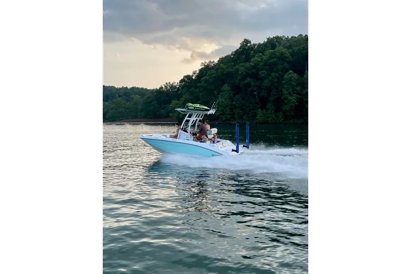 The Image of 2020 Yamaha Boats 195 FSH Sport cruising on a scenic lake. - 1