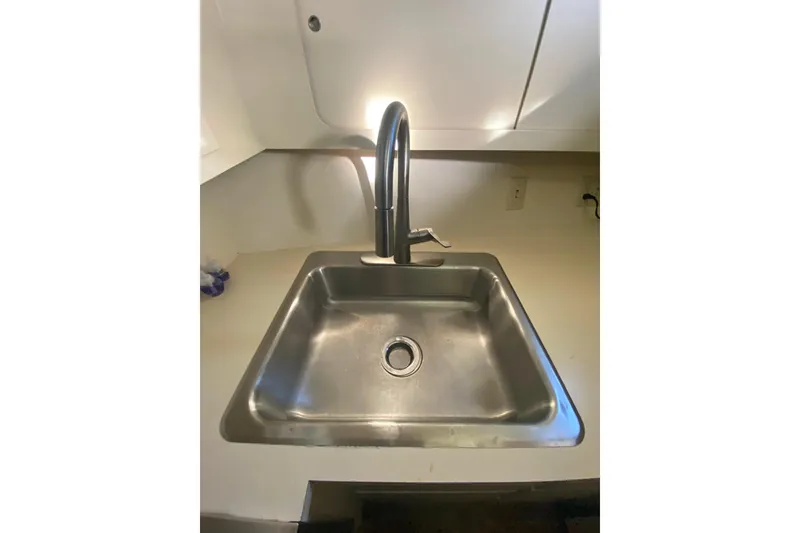 Slide: The Image of Stainless steel sink with modern faucet in 1988 Hatteras 40 Double Cabin yacht. - 14