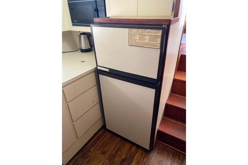 Slide: The Image of 1988 Hatteras 40 Double Cabin kitchen with refrigerator, microwave, and kettle. - 15