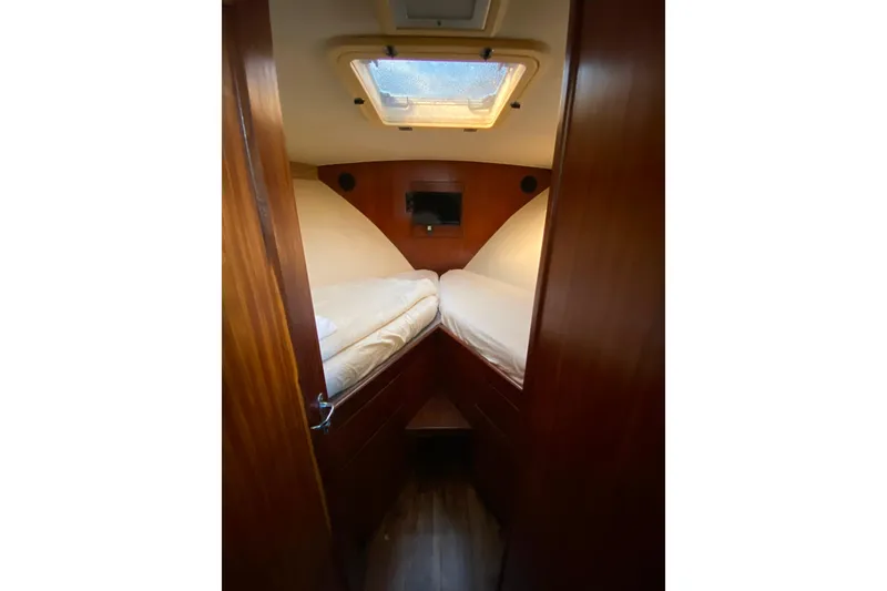 Slide: The Image of 1988 Hatteras 40 Double Cabin interior with twin beds and wooden finish. - 19