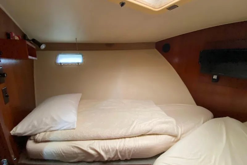 Slide: The Image of Cozy cabin interior of 1988 Hatteras 40 Double Cabin yacht with bed and porthole. - 21