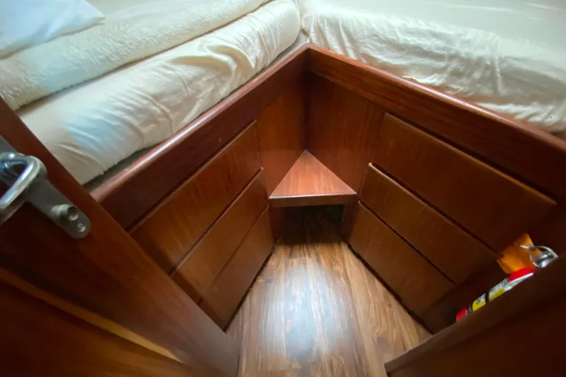 Slide: The Image of Cozy cabin interior of 1988 Hatteras 40 Double Cabin with wooden drawers and bed. - 22