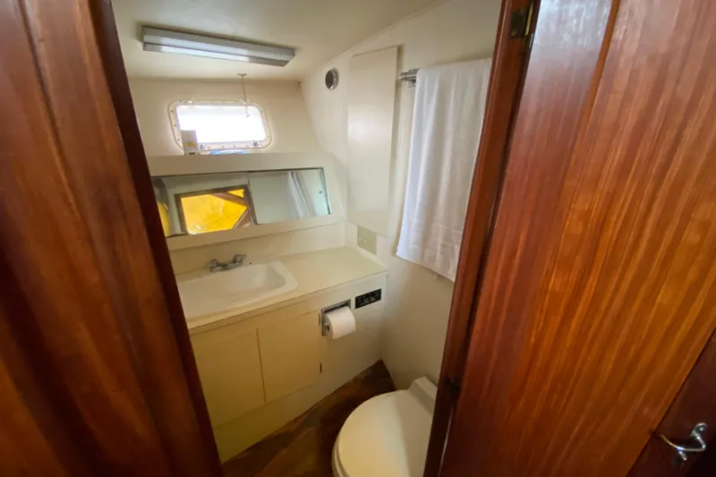 Slide: The Image of Bathroom interior of 1988 Hatteras 40 Double Cabin yacht, featuring sink and mirror. - 25
