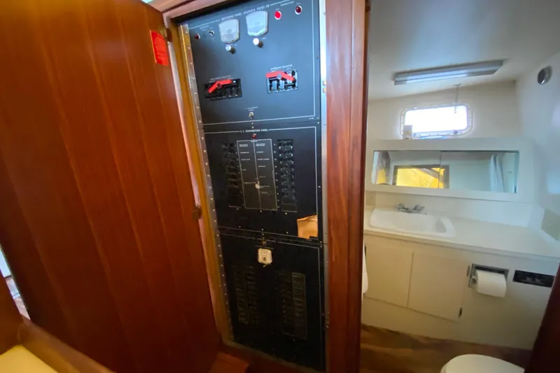 Slide: The Image of 1988 Hatteras 40 Double Cabin interior with electrical panel and bathroom view. - 27