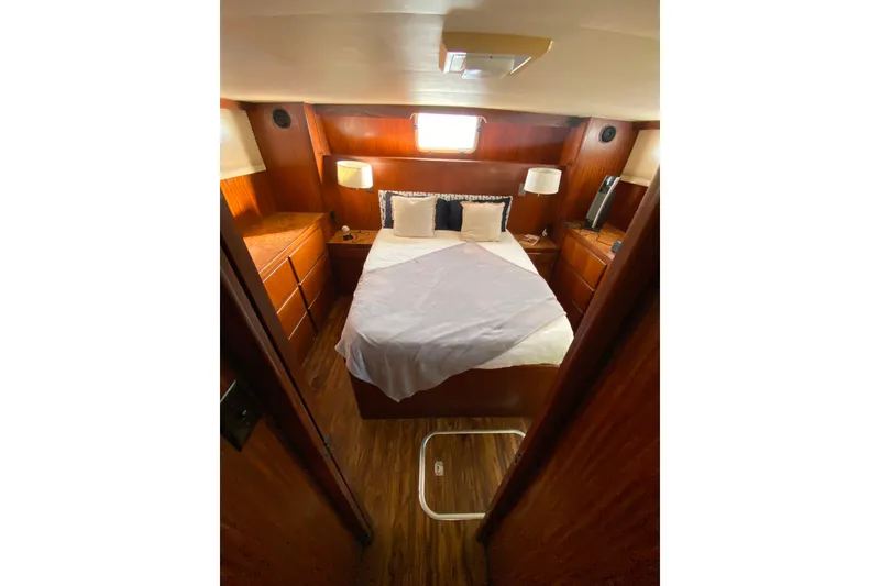 Slide: The Image of Cozy cabin interior of 1988 Hatteras 40 Double Cabin yacht with bed and wooden furnishings. - 28