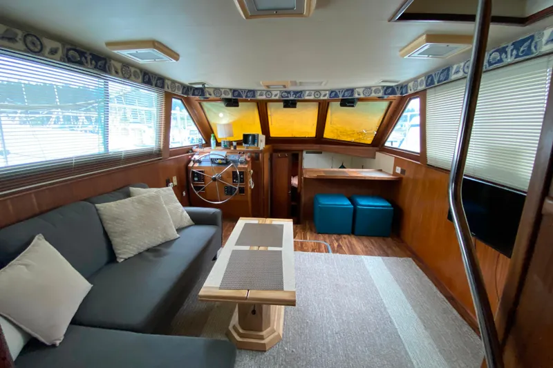 Slide: The Image of Interior of 1988 Hatteras 40 Double Cabin yacht with cozy seating and helm. - 3