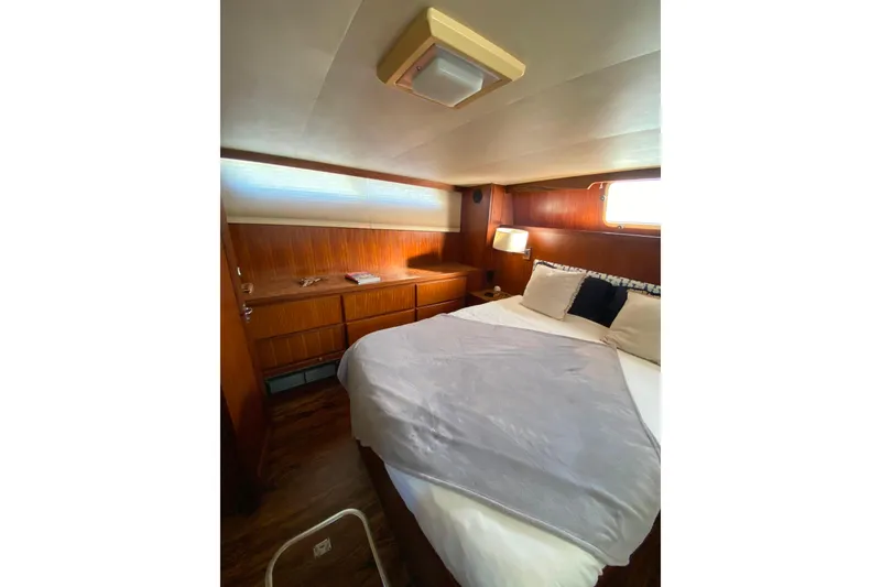Slide: The Image of Cozy cabin interior of 1988 Hatteras 40 Double Cabin yacht with bed and wooden furnishings. - 30