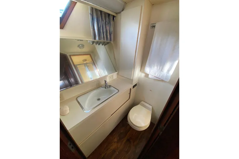 Slide: The Image of Bathroom interior of 1988 Hatteras 40 Double Cabin yacht, featuring sink and toilet. - 32