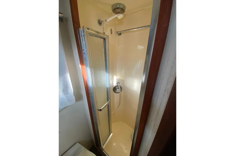 Slide: The Image of Shower area in 1988 Hatteras 40 Double Cabin yacht, featuring glass door and compact design. - 33