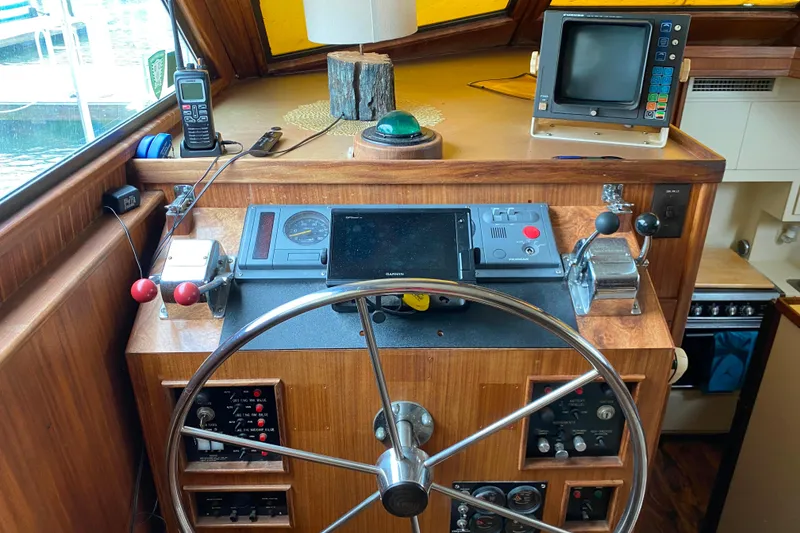 Slide: The Image of Helm of 1988 Hatteras 40 Double Cabin with navigation equipment and controls. - 34