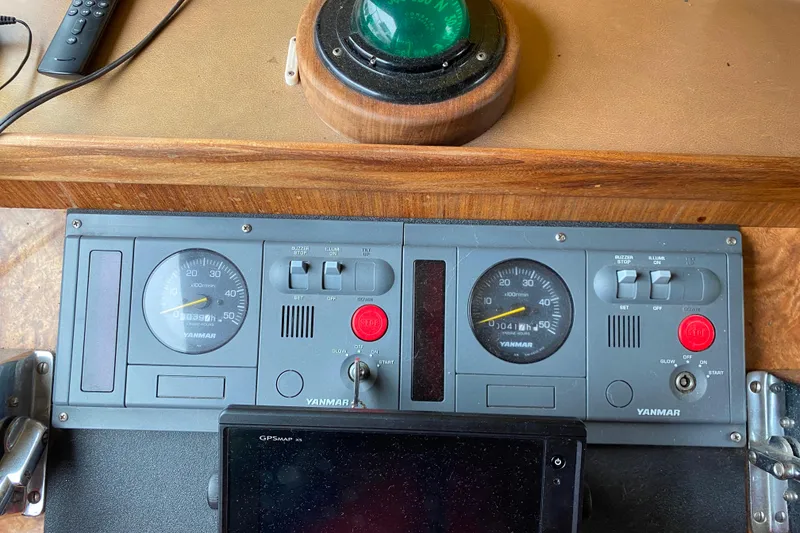 Slide: The Image of Control panel of a 1988 Hatteras 40 Double Cabin with Yanmar gauges and GPS device. - 35