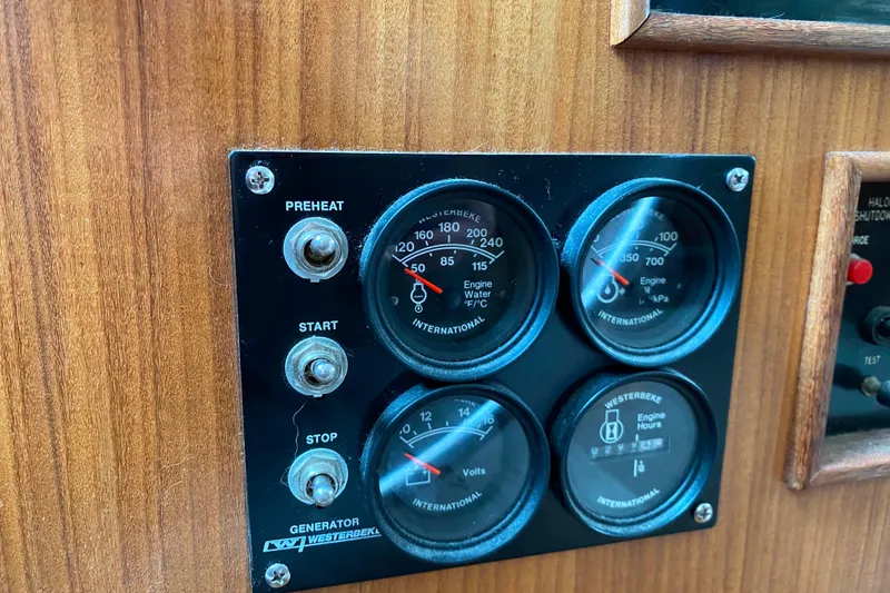 Slide: The Image of Control panel of a 1988 Hatteras 40 Double Cabin boat with gauges and switches. - 38