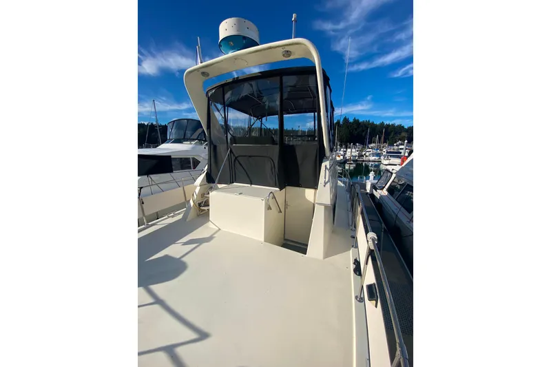 Slide: The Image of 1988 Hatteras 40 Double Cabin yacht docked at marina under clear blue sky. - 39