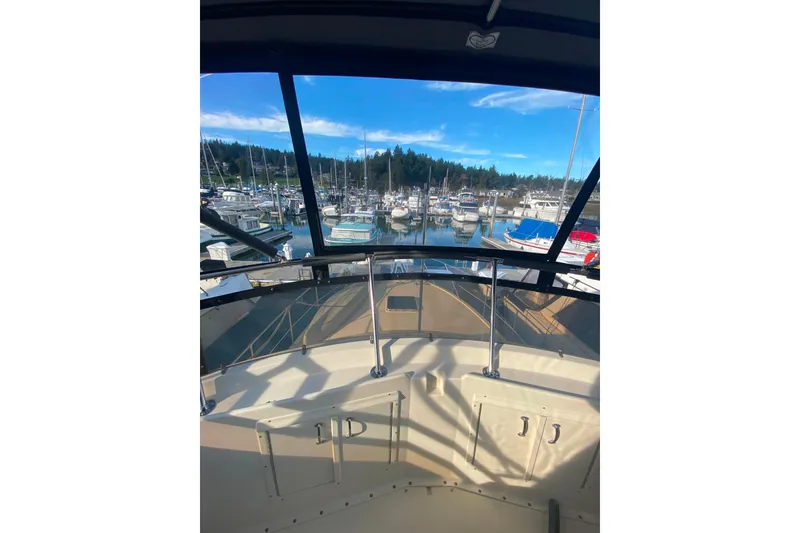 Slide: The Image of 1988 Hatteras 40 Double Cabin yacht view from helm at marina. - 43