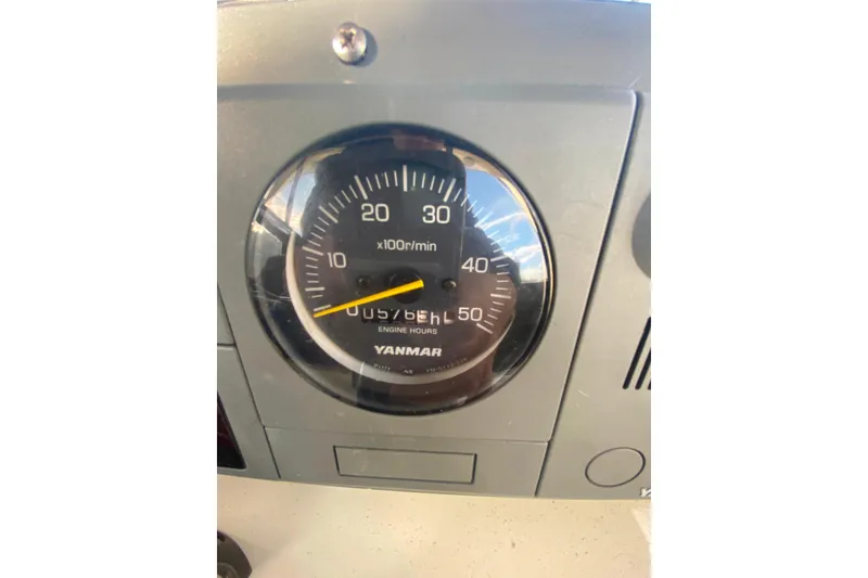 Slide: The Image of Yanmar engine tachometer on 1988 Hatteras 40 Double Cabin boat dashboard. - 45