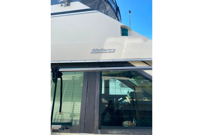 Slide: The Image of 1988 Hatteras 40 Double Cabin yacht exterior with logo and window detail. - 47