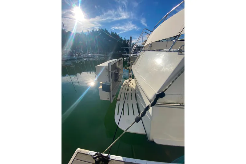 Slide: The Image of 1988 Hatteras 40 Double Cabin yacht docked under sunny skies. - 49