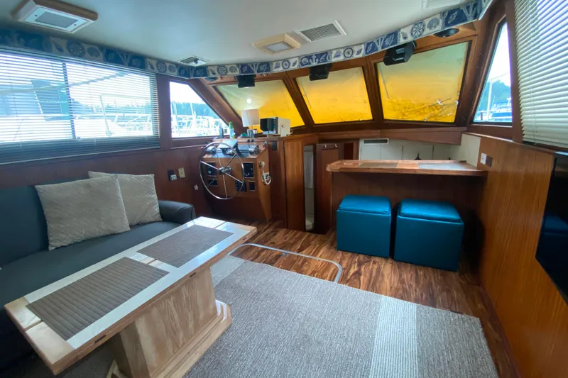 Slide: The Image of Interior of 1988 Hatteras 40 Double Cabin yacht with helm, seating, and wood accents. - 5