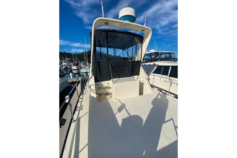 Slide: The Image of 1988 Hatteras 40 Double Cabin yacht docked under clear blue sky. - 51
