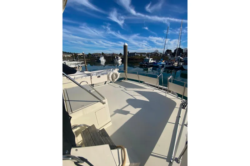 Slide: The Image of 1988 Hatteras 40 Double Cabin yacht deck with marina view under blue sky. - 52