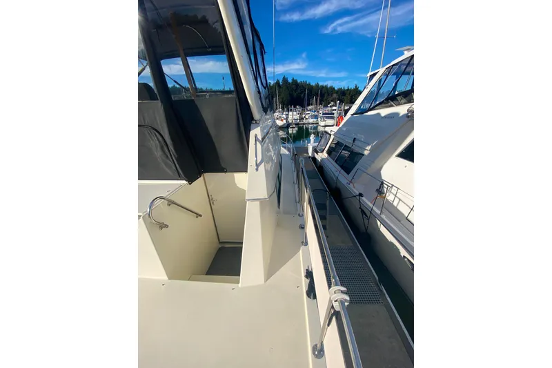 Slide: The Image of 1988 Hatteras 40 Double Cabin yacht docked at marina under clear blue sky. - 54