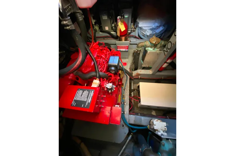 Slide: The Image of Engine room of 1988 Hatteras 40 Double Cabin with red machinery and wiring. - 59