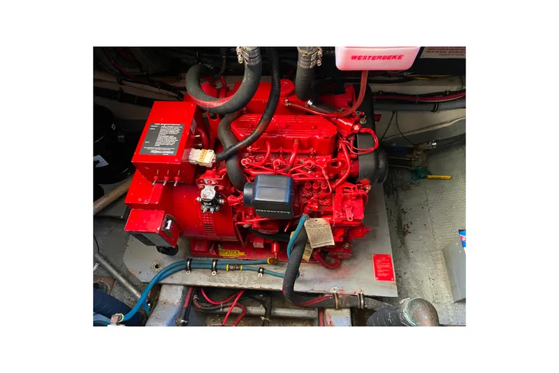 Slide: The Image of Engine compartment of 1988 Hatteras 40 Double Cabin with red Westerbeke generator. - 61