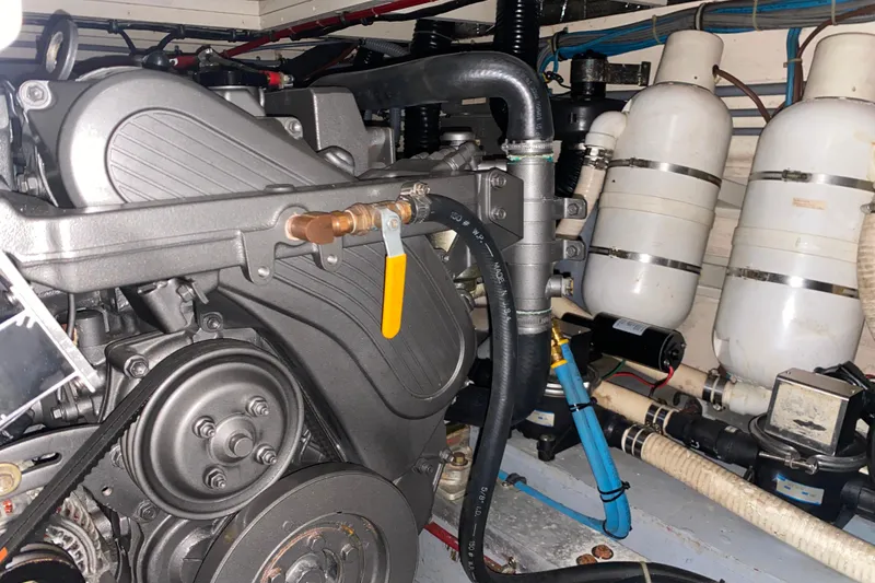 Slide: The Image of Engine room of 1988 Hatteras 40 Double Cabin with visible machinery and components. - 62