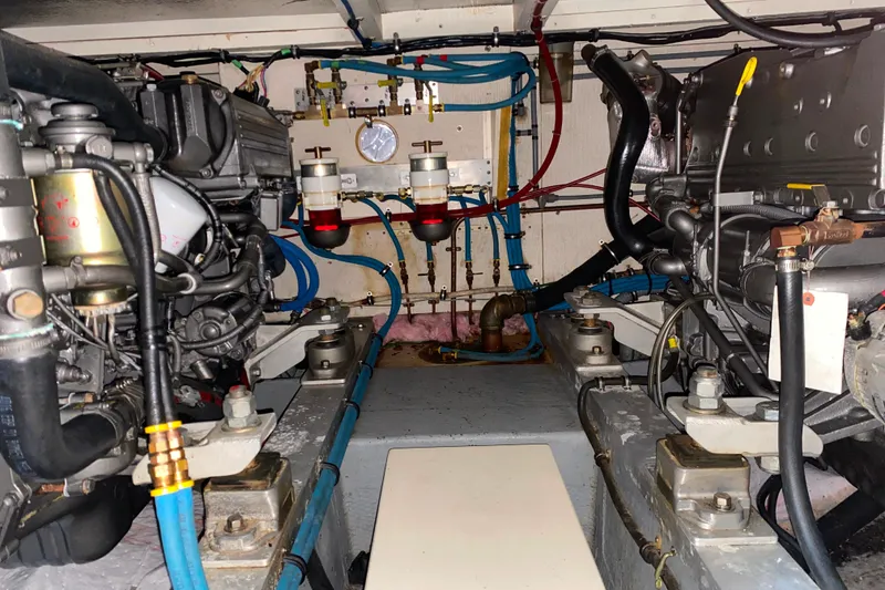 Slide: The Image of Engine room of 1988 Hatteras 40 Double Cabin with visible machinery and piping. - 63