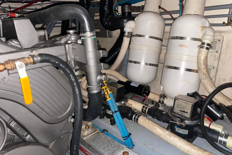 Slide: The Image of Engine room of 1988 Hatteras 40 Double Cabin with visible hoses and components. - 64