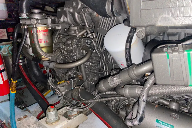 Slide: The Image of Engine compartment of a 1988 Hatteras 40 Double Cabin boat, showcasing detailed machinery. - 67