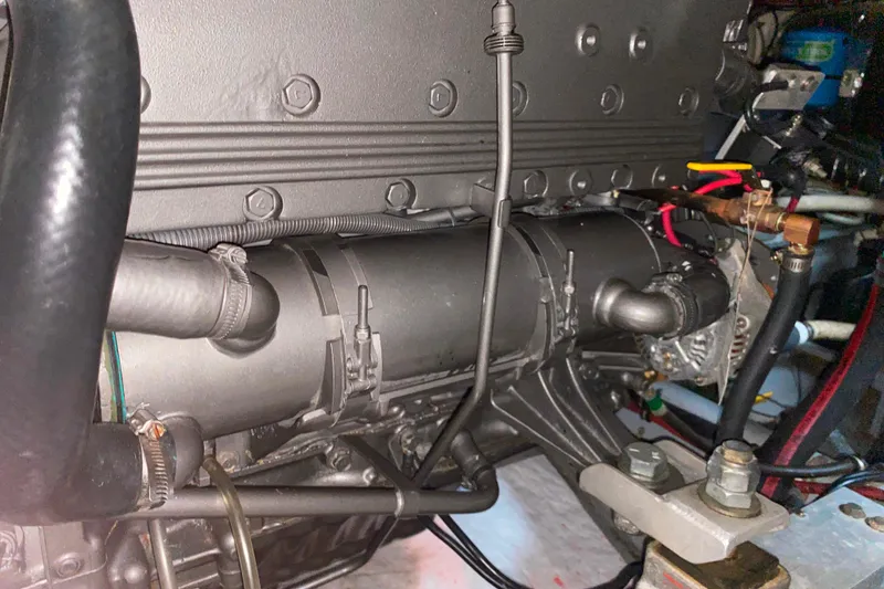 Slide: The Image of Engine compartment of 1988 Hatteras 40 Double Cabin boat, showcasing mechanical components. - 68