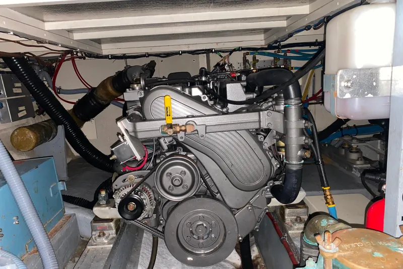 Slide: The Image of Engine room of 1988 Hatteras 40 Double Cabin yacht, showcasing mechanical components. - 69