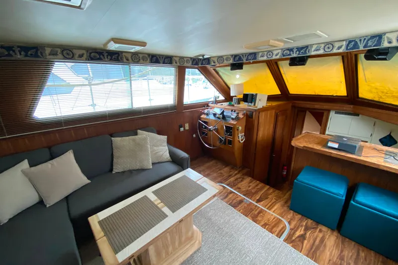 Slide: The Image of Interior of 1988 Hatteras 40 Double Cabin with cozy seating and helm station. - 7